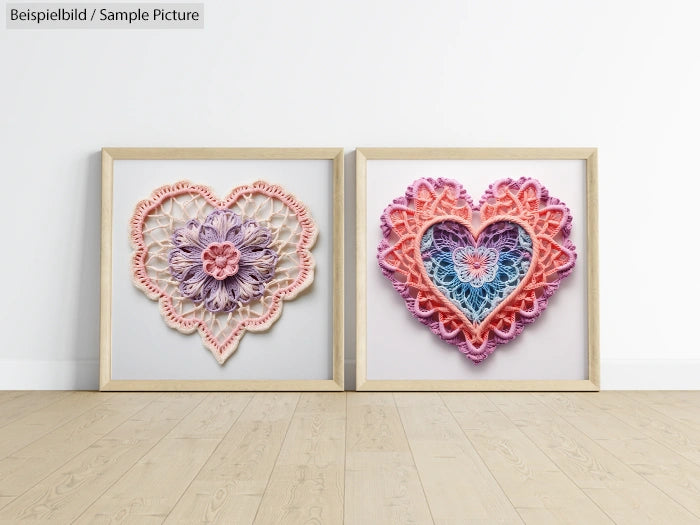 Two framed heart-shaped lace art pieces on a wooden floor, one in light pink-purple and the other in vibrant pink-blue.