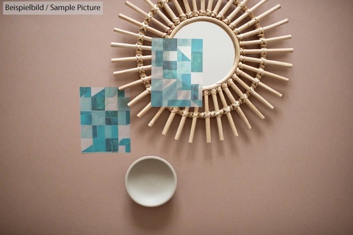 Sunburst mirror, teal square art pieces, and round dish on brown background.