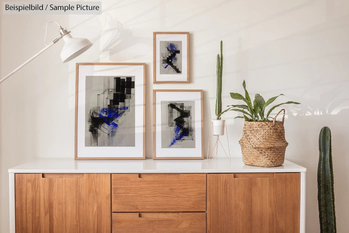 Modern interior with wooden cabinet, abstract framed art, and potted cacti decor.