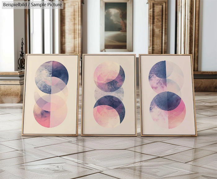 Three abstract paintings with overlapping circles in blue and pink hues, displayed in an elegant gallery setting.