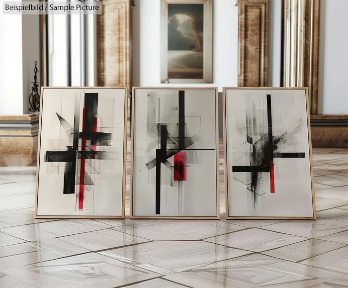 Three abstract paintings with intersecting black, white, and red lines displayed in a modern gallery setting.