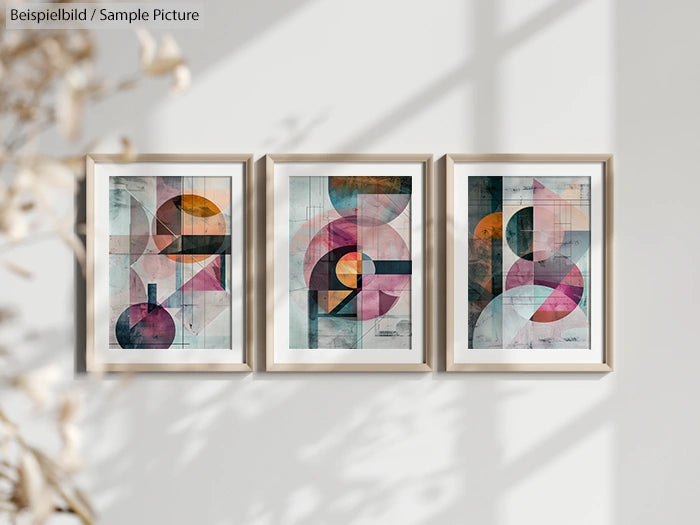 Three abstract geometric art prints with circles and intersecting shapes in vibrant colors, framed and hung on a white wall.