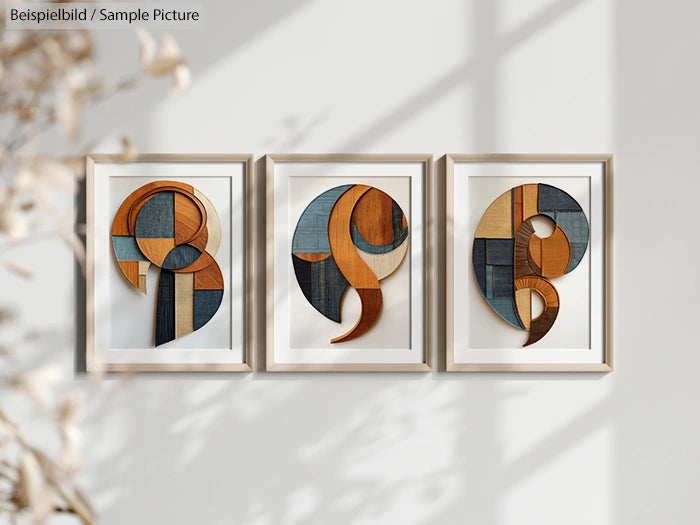 Three framed abstract artworks with wood and fabric geometric patterns on a sunlit wall.