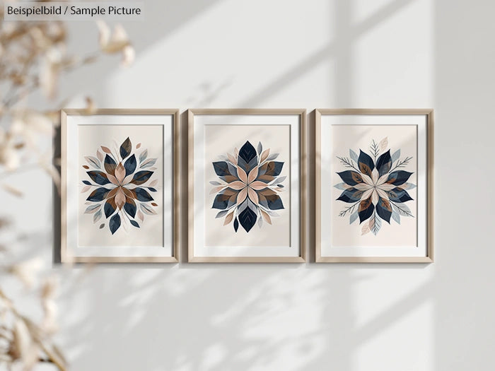 Three framed botanical art prints with abstract leaf designs in shades of blue and brown, displayed on a light wall.