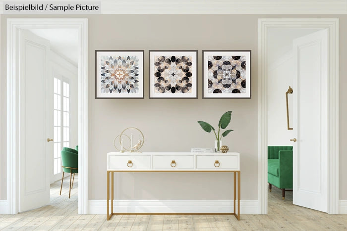 Modern living room with white console table, decorative objects, and three framed geometric prints on a beige wall.