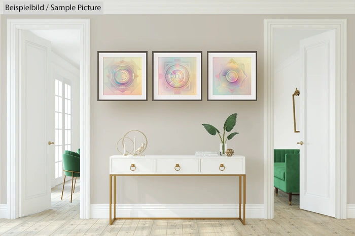 Modern living room with three abstract rainbow art pieces above white console table and green chairs.