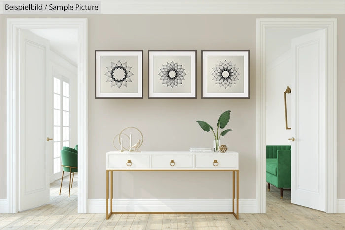 Minimalist living room with geometric art above console table, plants, and wooden floor.