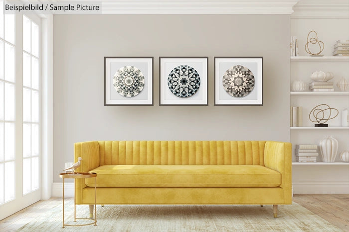 Modern living room with yellow sofa, three framed mandala artworks on wall, and decorative shelves on the side.