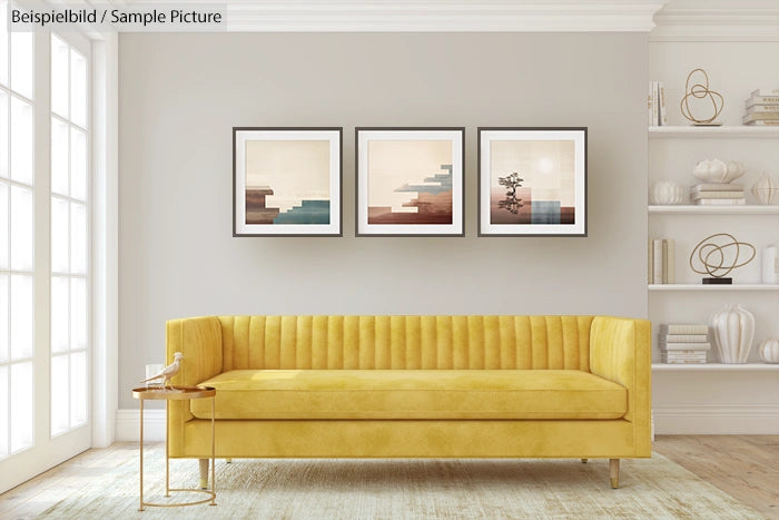 Modern living room with yellow sofa, abstract framed art, and minimalist decor on shelves.