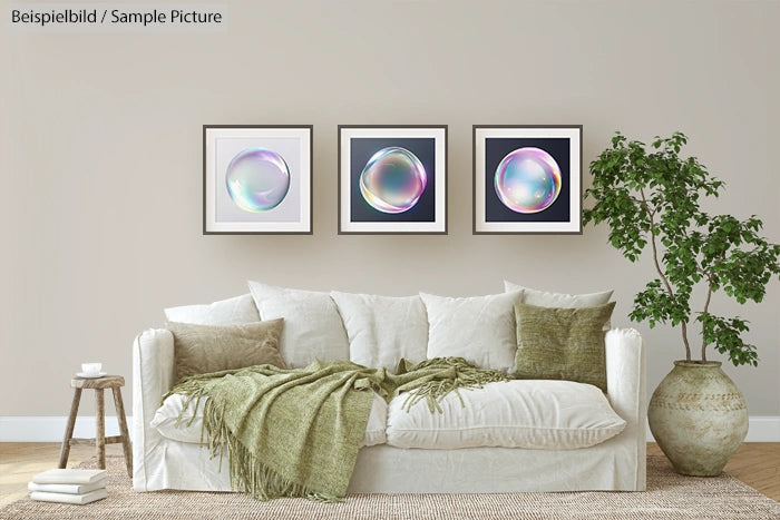 Modern living room with white sofa, green cushions, and three framed abstract art pieces on the wall.