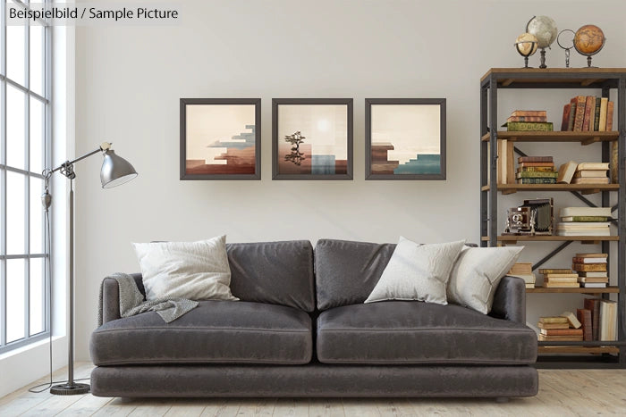 Modern living room with gray sofa, bookshelves, and three abstract paintings on the wall.