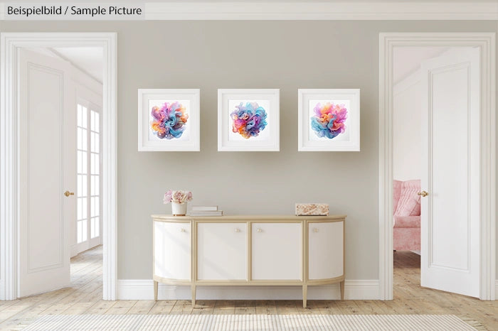 Modern living room with three abstract framed artworks above a minimalist sideboard.