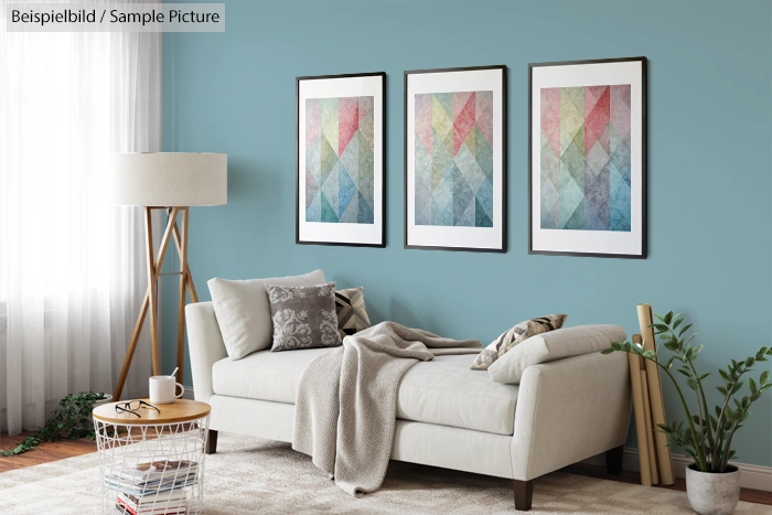 Modern living room with a beige sofa, geometric artwork, and teal walls, featuring minimal decor and natural light.