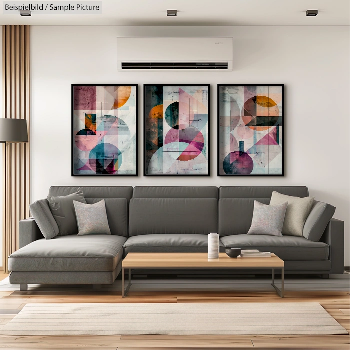 Modern living room with gray sectional sofa, wooden coffee table, and three abstract paintings on the wall.