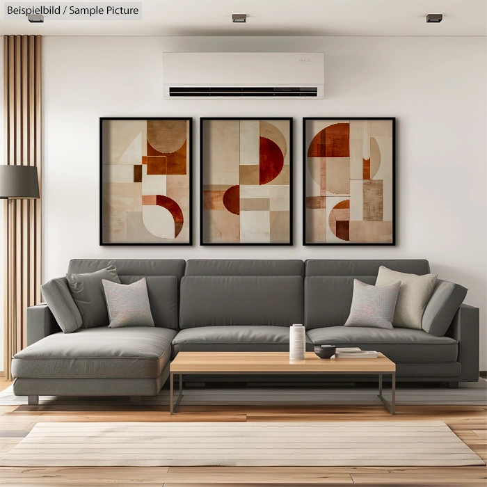 Modern living room with abstract geometric art, grey sectional sofa, and minimalist decor. Neutral tones and clean lines.