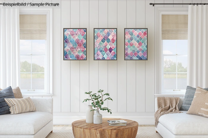 Bright living room with two beige sofas, a wooden coffee table, and three colorful abstract paintings on the wall.