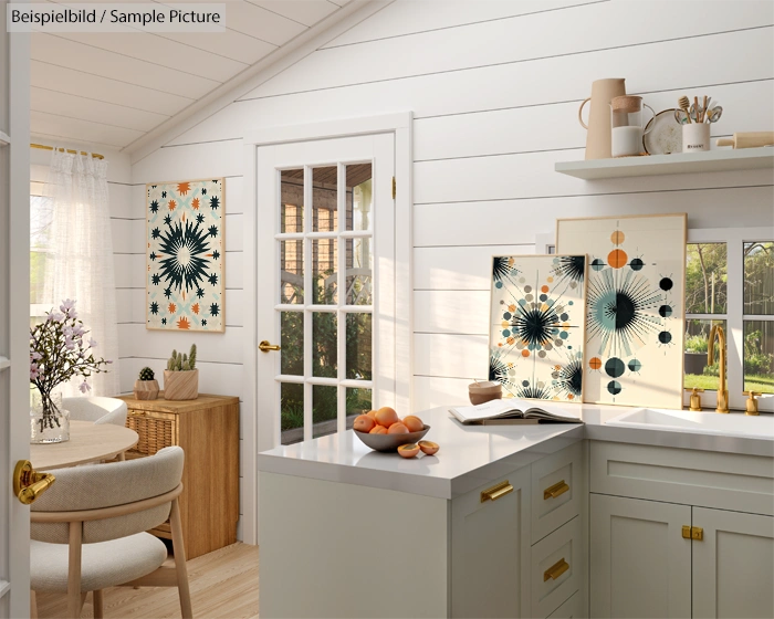 Bright kitchen with modern decor, featuring geometric art, white counters, and fruit bowl on an island near a sunlit door.