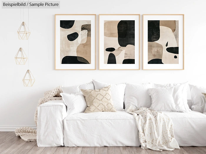 Minimalist living room with a white sofa and abstract art on the wall, featuring neutral tones and geometric patterns.