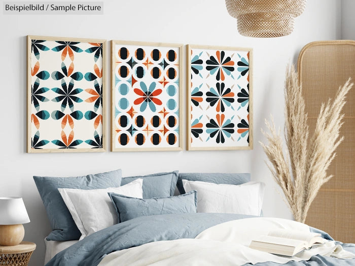 Modern bedroom with blue bedding, abstract art prints on the wall, and decorative pampas grass in a cozy setting.