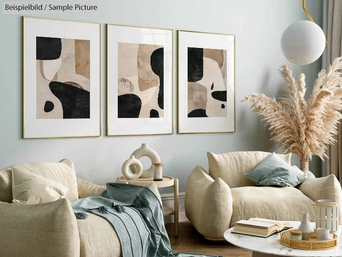 Modern living room with beige armchairs, abstract art on wall, and pampas grass décor.