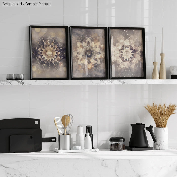 Kitchen shelf with three framed geometric art pieces, utensils, a black kettle, and decorative items.