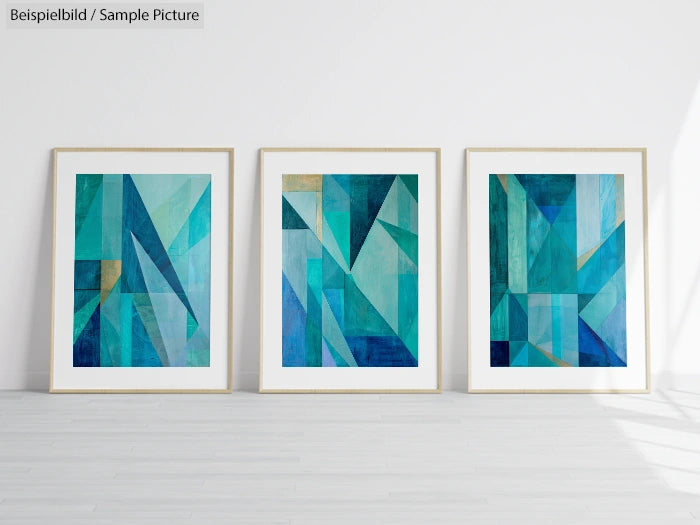 Three abstract geometric paintings in blue tones, framed and displayed on a white wall.