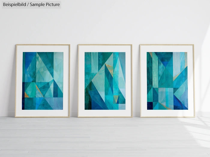 Three framed abstract geometric paintings with blue and green tones on a clean white wall with light wooden floor.