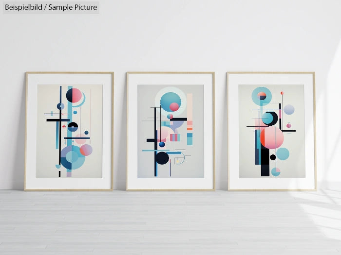 Three framed abstract geometric art prints with circles and lines in pastel colors against a white wall.