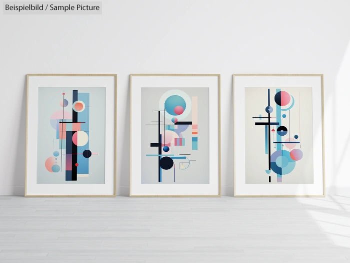 Three geometric abstract art prints with circles and lines in pastel colors, framed and displayed against a white wall.