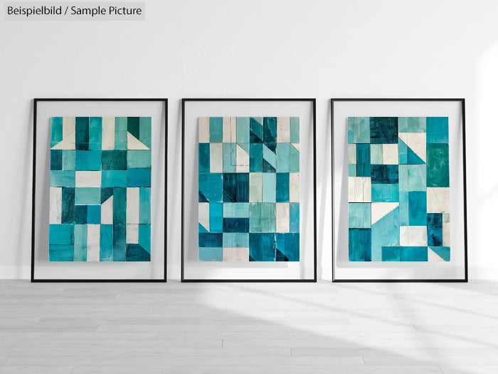 Set of three framed abstract paintings with geometric blue and teal patterns on a white wall.