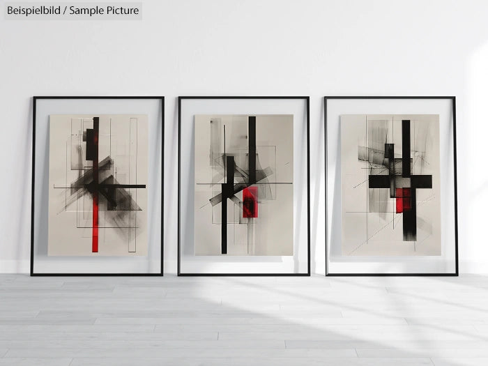 Set of three framed abstract paintings with black and red geometric designs on a light background.