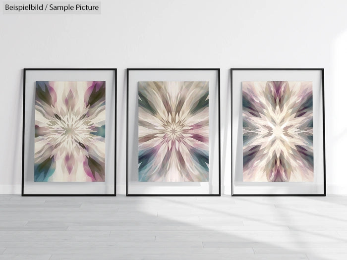 Three framed abstract artworks with symmetric starburst patterns in soft pastel colors, displayed on a minimalist wall.