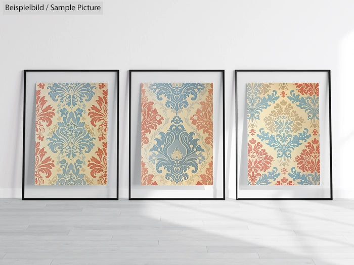 Three framed decorative patterns with floral designs in red, blue, and beige, displayed against a white wall.