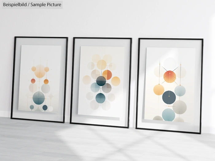 Minimalist art prints with geometric circle designs in frames on a white wall, casting shadows on the floor.