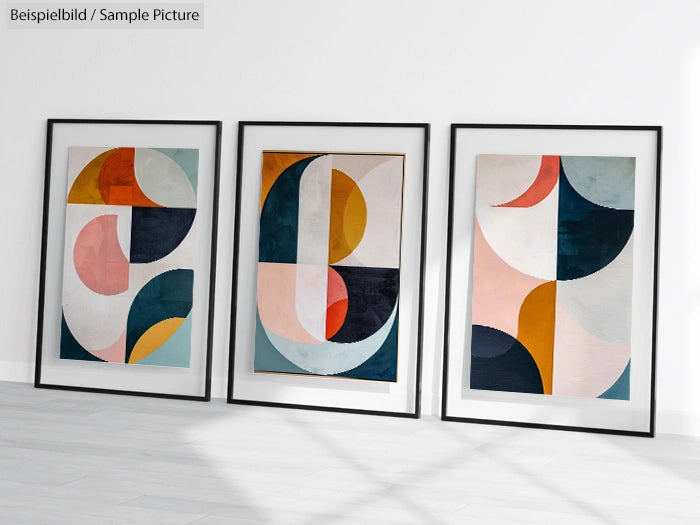 Three abstract geometric paintings with circles and arcs in black frames, placed on a white background.