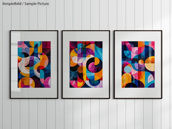 Three framed abstract art pieces with colorful geometric patterns on a white wall.