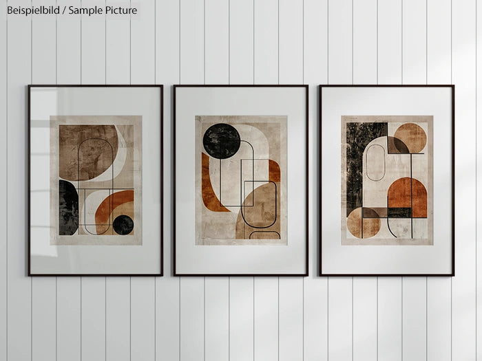 Three framed abstract geometric artworks with circles, rectangles, and earth tones on a white paneled wall.