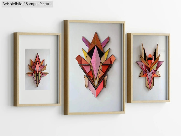 Three framed geometric abstract artworks in shades of red, orange, and pink, displayed on a white wall.