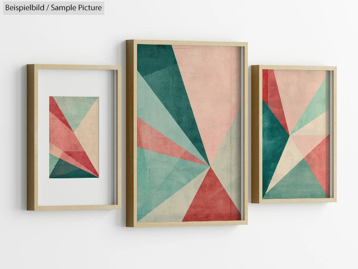 Three framed geometric art prints with red, green, and beige triangles on a white wall.