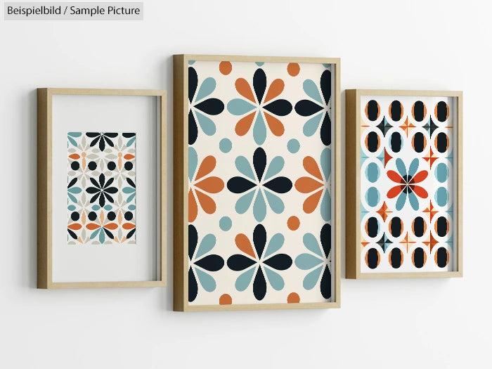 Set of three framed geometric art prints with floral patterns and bold colors on a light wall.