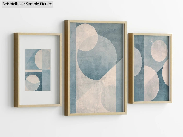 Three framed abstract geometric paintings with circular designs in blue and beige tones on a white wall.