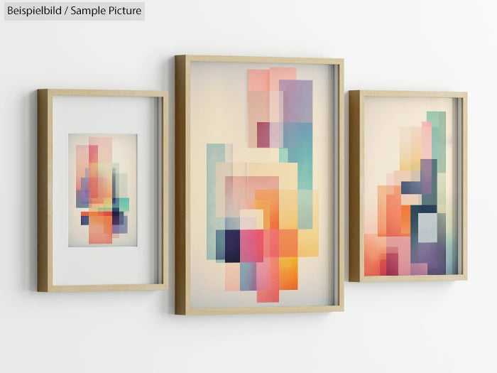 Three framed abstract artwork pieces with colorful geometric shapes on a white wall.