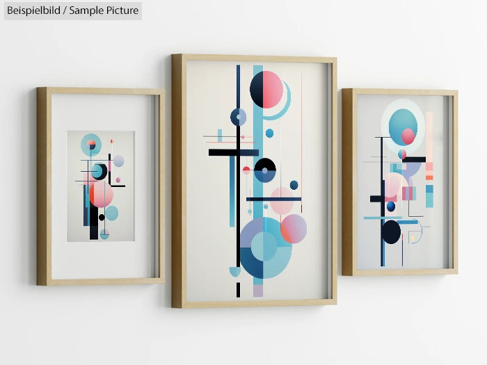 Three abstract geometric artworks in wooden frames with circles and lines in pink, blue, and black on white background.