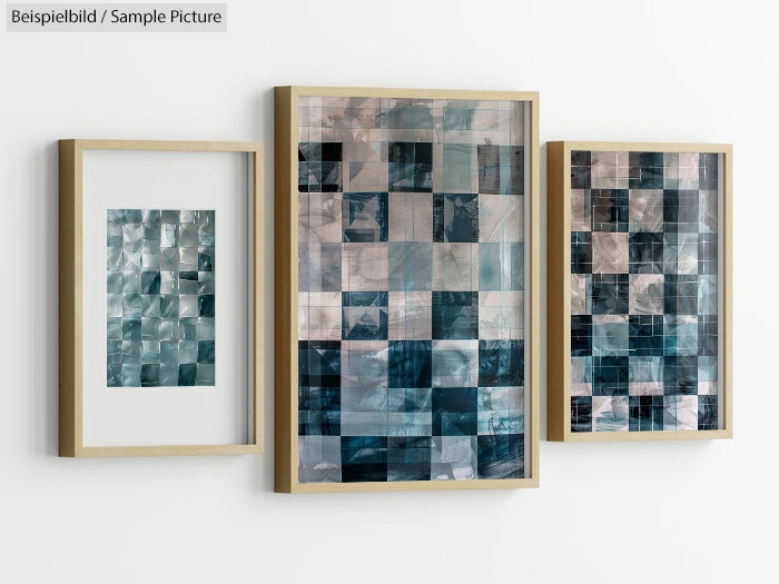 Three abstract artworks in wooden frames, featuring geometric blue and gray patterns, hung on a white wall.