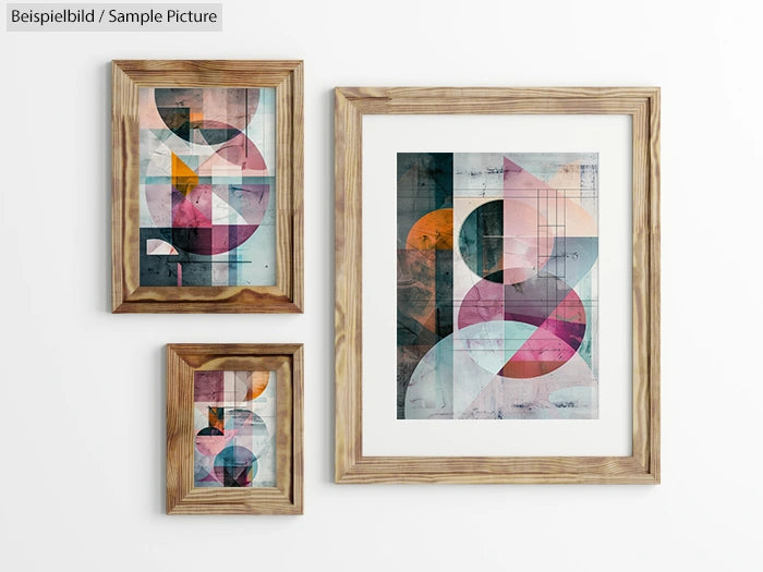 Three abstract geometric artworks in wooden frames on a white wall, featuring colorful circles and angular shapes.