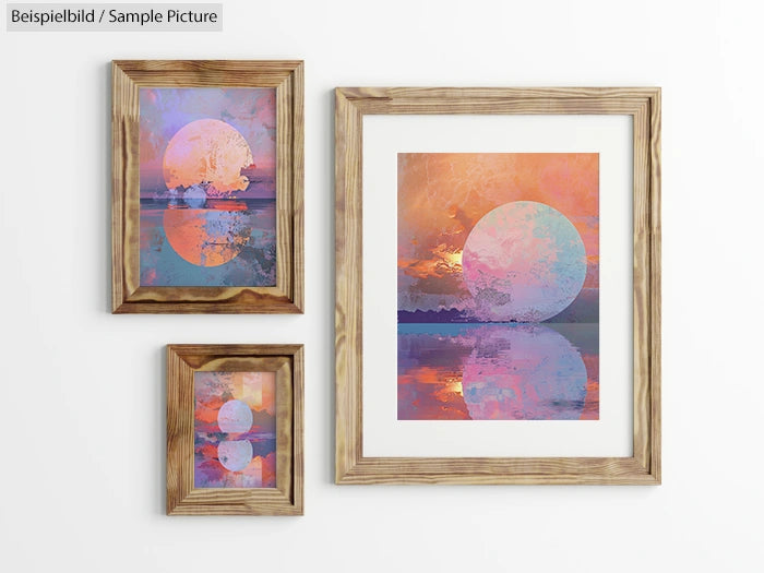 Gallery wall with framed abstract prints of sunsets over water in warm colors, featuring a large and two small images.