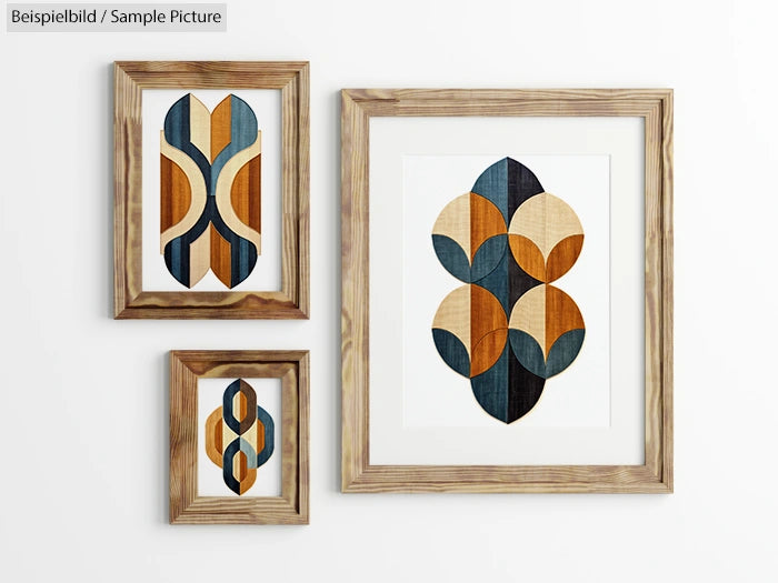 Art display with three wooden-framed abstract prints in blue, orange, and beige geometric shapes on a white wall.