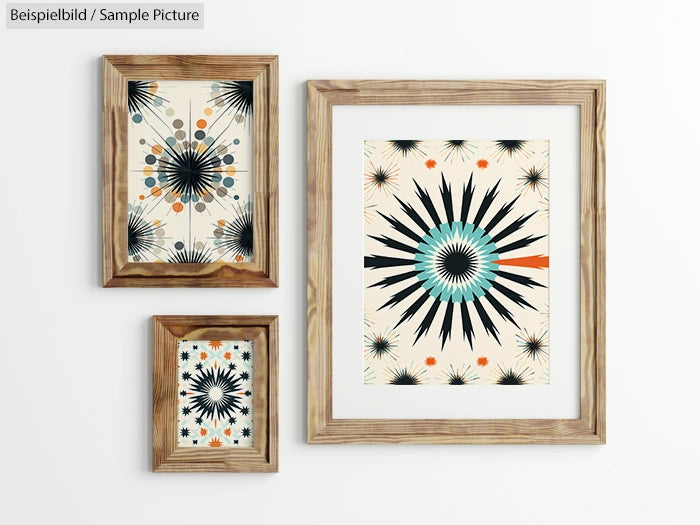 Three framed abstract artworks with geometric starburst designs in black, teal, and orange on a light background.