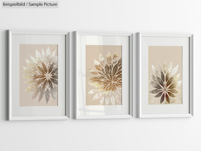 Three framed metallic leaf art prints on a white wall, each with a beige background and different leaf patterns.