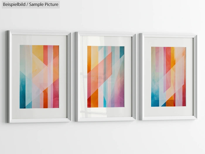 Three framed abstract art pieces with colored geometric patterns in a row on a white wall.